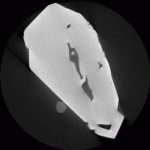 2D reconstruction of a single fluorite crystal, approximately 4 cm long, containing large two-phase fluid inclusions; the liquid phase appears dark gray and surrounds a vapor phase (black). X-ray CT is an accurate means of evaulating primary vs. secondary inclusions, and allows for precise volume measurements of liquid and vapor phases so that a homogenization temperature can be derived without destroying the sample. In addition to imaging rare specimens, this technique is also favorable for unstable minerals that might produce questionable results due to fluid inclusion stretching caused by heating during sample preparation or during conventional homogenization. (Sample provided by J. Richard Kyle, The University of Texas)